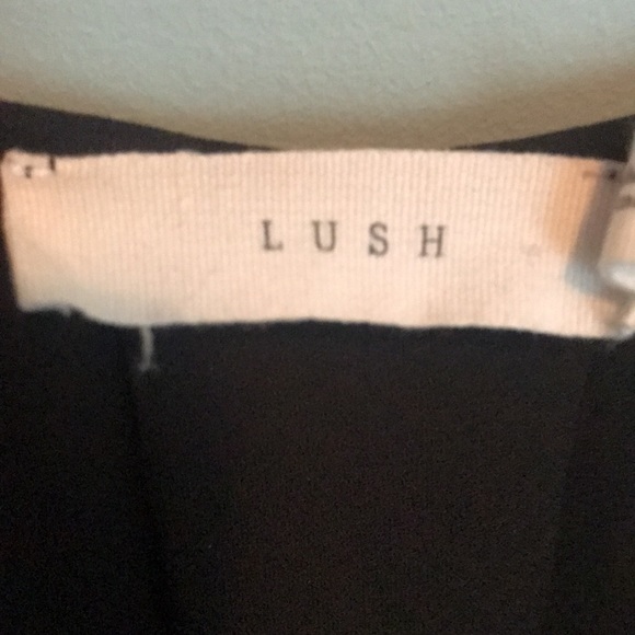 Lush black asymmetrical top with button cuff sleeves. Size: M - Picture 2 of 4